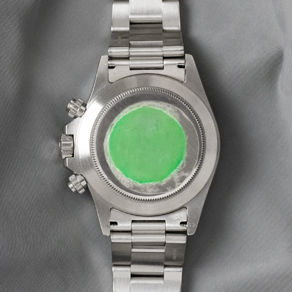 Green sticker on back of cheap rolex